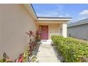 Inviting front porch with a decorative wreath and meticulously landscaped walkway at 1022 Chandler Snowden Ct, Ruskin, FL 33570