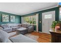 Cozy living room featuring a comfortable sectional sofa, wood floors, and a bright window at 1526 San Mateo Dr, Dunedin, FL 34698