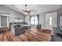 Inviting living room with hardwood floors, ceiling fan, and comfortable gray sectional sofa at 1851 Skyland Dr, Clearwater, FL 33759