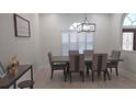 Dining room with hardwood floors, shutters on the windows and modern decor at 1961 Dunbrody Ct, Dunedin, FL 34698