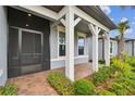 Inviting front porch framed by white columns and lush landscaping creating a cozy entrance at 20033 Sea Glass Cir, Land O Lakes, FL 34638
