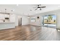 Spacious living room with wood floors, plenty of natural light, and sliding doors to the patio at 20033 Sea Glass Cir, Land O Lakes, FL 34638