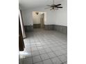 Spacious living room featuring tile floors, a ceiling fan, and ample natural light at 2026 Aaron Pl, Clearwater, FL 33760