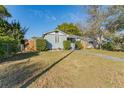 Inviting home with lush lawn, mature trees, and a walkway leading to a quaint entrance at 2035 29Th N Ave, St Petersburg, FL 33713