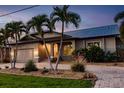 Beautiful shot of the front elevation and landscaping of this single Gathering home at 2100 Aqui Esta Dr, Punta Gorda, FL 33950