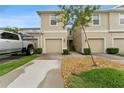 Inviting townhome featuring a one car garage, neutral paint and well maintained landscaping at 2129 Lennox Dale Ln, Brandon, FL 33510