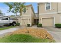 Inviting townhome featuring a one car garage, neutral paint and well maintained landscaping at 2129 Lennox Dale Ln, Brandon, FL 33510