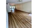 Spacious living room with wood-look flooring and a mirrored wall at 2360 Irish Ln # 16, Clearwater, FL 33763