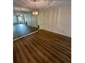 Living room with new wood floors and a decorative light fixture at 2360 Irish Ln # 16, Clearwater, FL 33763