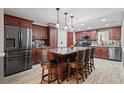 Spacious kitchen boasts wood cabinetry, a marble island, and modern stainless steel appliances at 3413 W Kirby St, Tampa, FL 33614