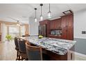 Beautiful kitchen with a marble island, stainless steel appliances, and stylish pendant lighting at 3413 W Kirby St, Tampa, FL 33614