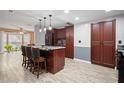 Open kitchen featuring a marble island with seating and stainless steel appliances at 3413 W Kirby St, Tampa, FL 33614