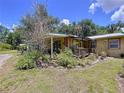 Charming home featuring an inviting covered porch adorned with lush greenery and potted plants, enhancing curb appeal at 3544 Porter Rd, Lithia, FL 33547