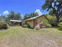 Ranch-style home featuring a metal roof, exterior brick accents, and a well-maintained yard at 3544 Porter Rd, Lithia, FL 33547