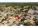 Expansive aerial view of a quiet residential neighborhood with lush greenery and waterfront access at 3640 Cheswick Dr, Holiday, FL 34691
