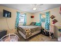 Cozy bedroom with natural light, comfortable bed, and charming decor accents at 3640 Cheswick Dr, Holiday, FL 34691
