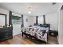 Stylish bedroom with dark wood floors, ceiling fan, and plenty of natural light at 3640 Cheswick Dr, Holiday, FL 34691