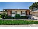 Charming single-story home with brick accents, manicured bushes, and well-kept lawn at 368 Perth Ct # 368, Dunedin, FL 34698