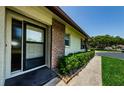Inviting front entrance with brick accents and manicured landscaping along the walkway at 368 Perth Ct # 368, Dunedin, FL 34698