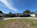 Charming single-story home with a well-manicured front lawn,solar panels, and an attached garage at 378 79Th Ne Ave, St Petersburg, FL 33702
