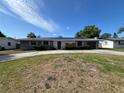 Single-story home with neutral paint, solar panels, well-maintained lawn, and an attached garage at 378 79Th Ne Ave, St Petersburg, FL 33702