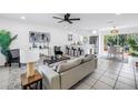 A bright and airy living room with an open floor plan and neutral decor that flows into the dining area at 3843 Neptune Se Dr, St Petersburg, FL 33705