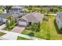 From above, the home features a neatly kept yard near other residences, with a pond adding to the peaceful setting at 3891 Reflection Dock Dr, Seffner, FL 33584