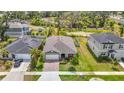 Beautiful aerial view showcases home's well-maintained lawn, neighboring houses, and serene pond in the background at 3891 Reflection Dock Dr, Seffner, FL 33584