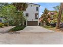 Charming stucco home featuring a two-car garage, balcony, and mature tree landscaping at 412 S Albany Ave # 2, Tampa, FL 33606