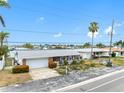 Charming single-story home with a well-manicured lawn, mature landscaping, and an attached garage, offering comfortable living at 440 115Th Ave, Treasure Island, FL 33706