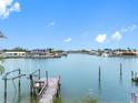 Expansive waterfront view showcases a serene waterway, docks, and beautiful homes under a bright blue sky at 440 115Th Ave, Treasure Island, FL 33706