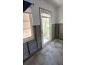 Interior door and window surrounded by unfinished walls, highlighting a possible renovation project at 4560 Overlook Ne Dr # 167, St Petersburg, FL 33703