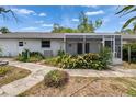 Landscaped backyard featuring a screened in porch and walkway at 508 E Brentridge, Brandon, FL 33511