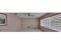 This bedroom features tiled floors, a ceiling fan, and horizontal blinds on the windows for filtered natural light at 508 E Brentridge, Brandon, FL 33511