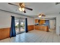 Open kitchen and dining area with tile floors, wood cabinets, and access to the outdoor patio at 508 E Brentridge, Brandon, FL 33511