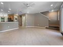 Open-concept living area with tile flooring and staircase, seamlessly connecting living, dining, and kitchen spaces at 5636 Whitehead St, Bradenton, FL 34203