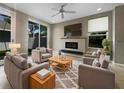 Contemporary living room with stylish furnishings, cozy fireplace, and ample natural light through sliding glass doors at 5636 Whitehead St, Bradenton, FL 34203
