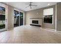 Bright and spacious living area featuring a fireplace, tile flooring, and seamless access to outdoor space at 5636 Whitehead St, Bradenton, FL 34203
