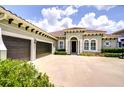 Beautiful single-story home featuring a large driveway, three-car garage and tile roof at 5728 Watercolor Dr, Lithia, FL 33547