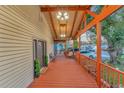 Wide front porch with wood floor, wood ceiling, and decorative accents at 7010 N Hubert Ave, Tampa, FL 33614