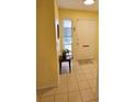 Warm foyer with tiled floors and a sunny yellow wall welcomes you into the home at 7303 9Th W Ave # 7303, Bradenton, FL 34209