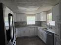Newly renovated kitchen with white cabinets and stone countertops at 7307 50Th N Ave, St Petersburg, FL 33709