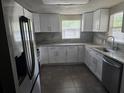Modern kitchen features stone counters and stainless steel sink at 7307 50Th N Ave, St Petersburg, FL 33709