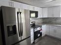Bright kitchen with stainless steel appliances and white cabinets at 7307 50Th N Ave, St Petersburg, FL 33709
