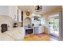 Cozy kitchen with stainless steel appliances, white cabinets, and brick accents at 75 Adalia Ave, Tampa, FL 33606