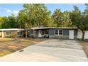 Charming single-story home with stone accents, neutral paint, well-maintained landscaping, and a welcoming front entrance at 8001 N Ola Ave, Tampa, FL 33604