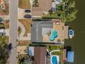 An aerial view showcases a private pool, boat dock, and thoughtfully landscaped surroundings at 8722 Thornwood Ln, Tampa, FL 33615