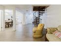 Spacious living room with hardwood floors, spiral staircase, and open floor plan at 1010 Oakhill St, Seffner, FL 33584
