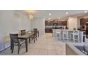 Bright dining area open to the kitchen, featuring a dark wood table and barstool seating at 10210 White Linen Ave, Riverview, FL 33578