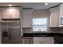 A well-equipped kitchen featuring stainless steel appliances, shaker cabinets, and black granite countertops at 1107 Howard St, Clearwater, FL 33756
